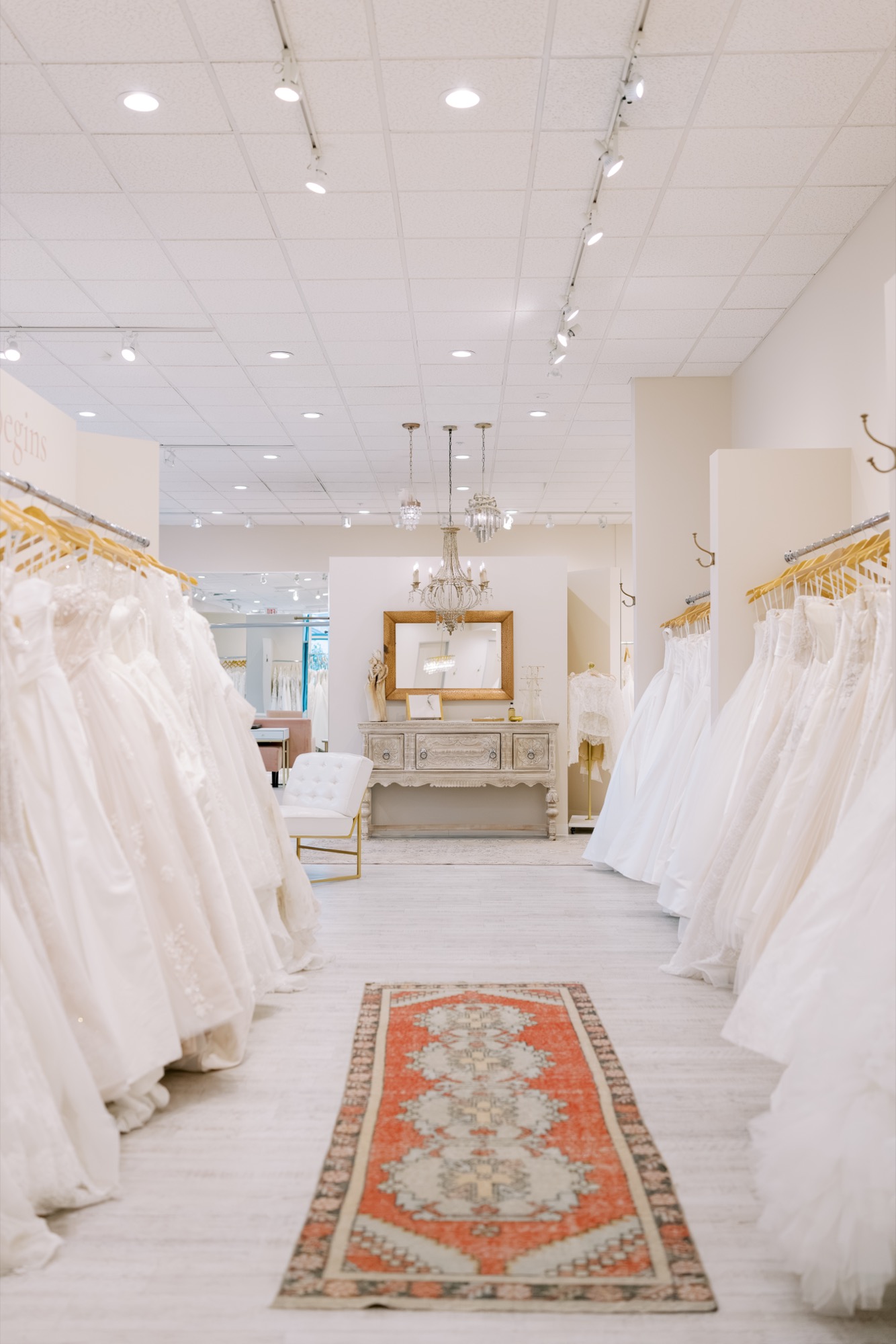 Bright Brickhouse Bridal showroom interior with seating and gowns