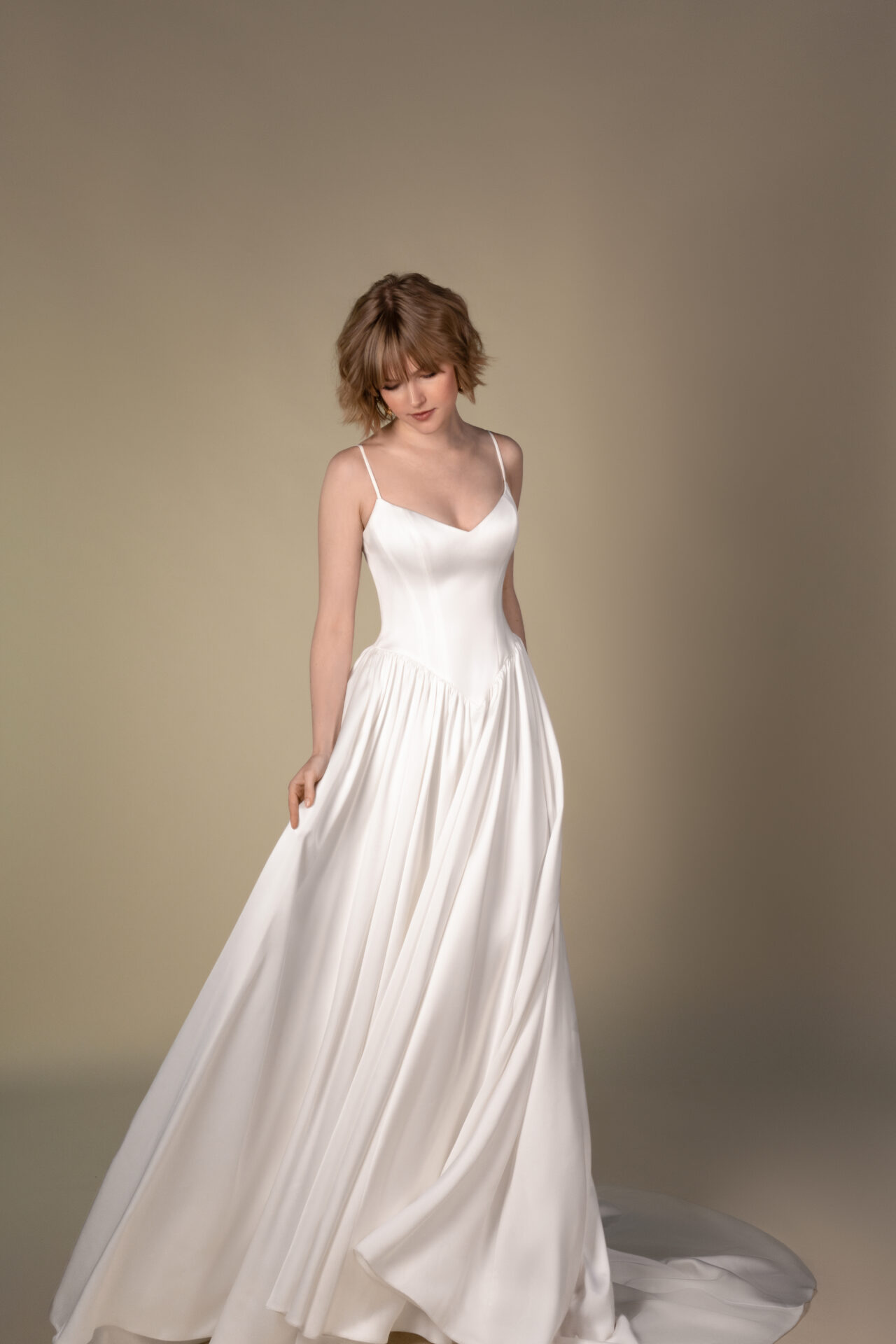 Bride in an All Who Wander spaghetti-strap satin a-line gown