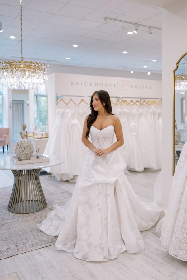 Bride in a beaded Martina Liana Luxe ballgown beneath a crystal chandelier
