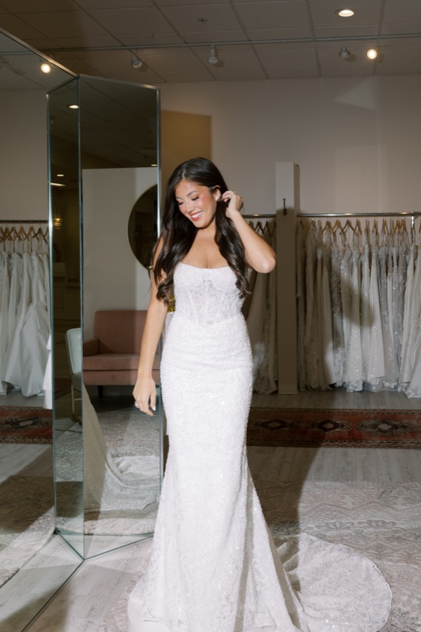 Bride in a fitted lace wedding gown reflected in a mirror at Brickhouse Bridal