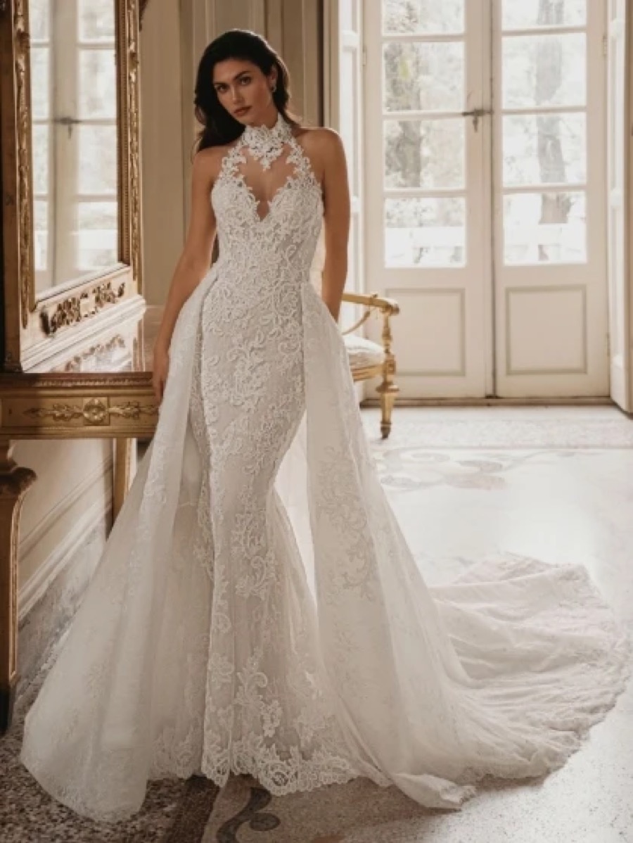 Bride in an Enzoani halter-neck lace mermaid gown with detachable overskirt