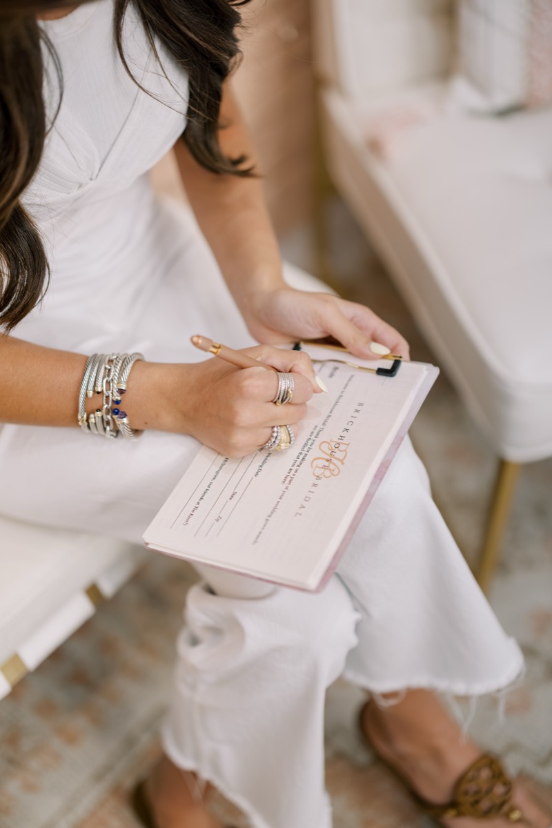 Stylist consulting with a bride in the showroom