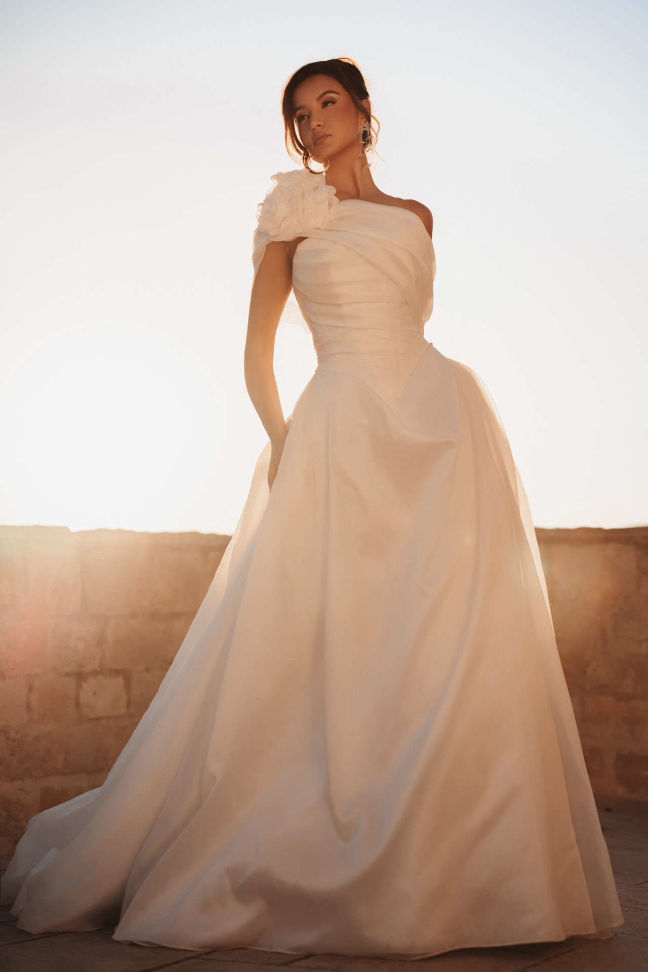 Bride in a Martina Liana one-shoulder ballgown with a fabric rose detail
