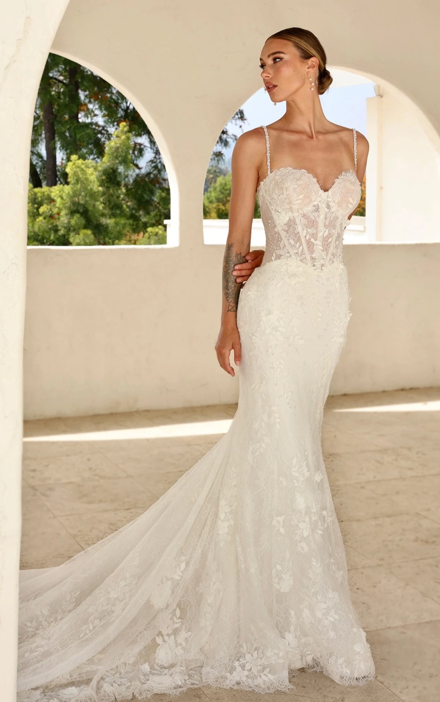 Bride in a Martina Liana spaghetti-strap lace mermaid gown