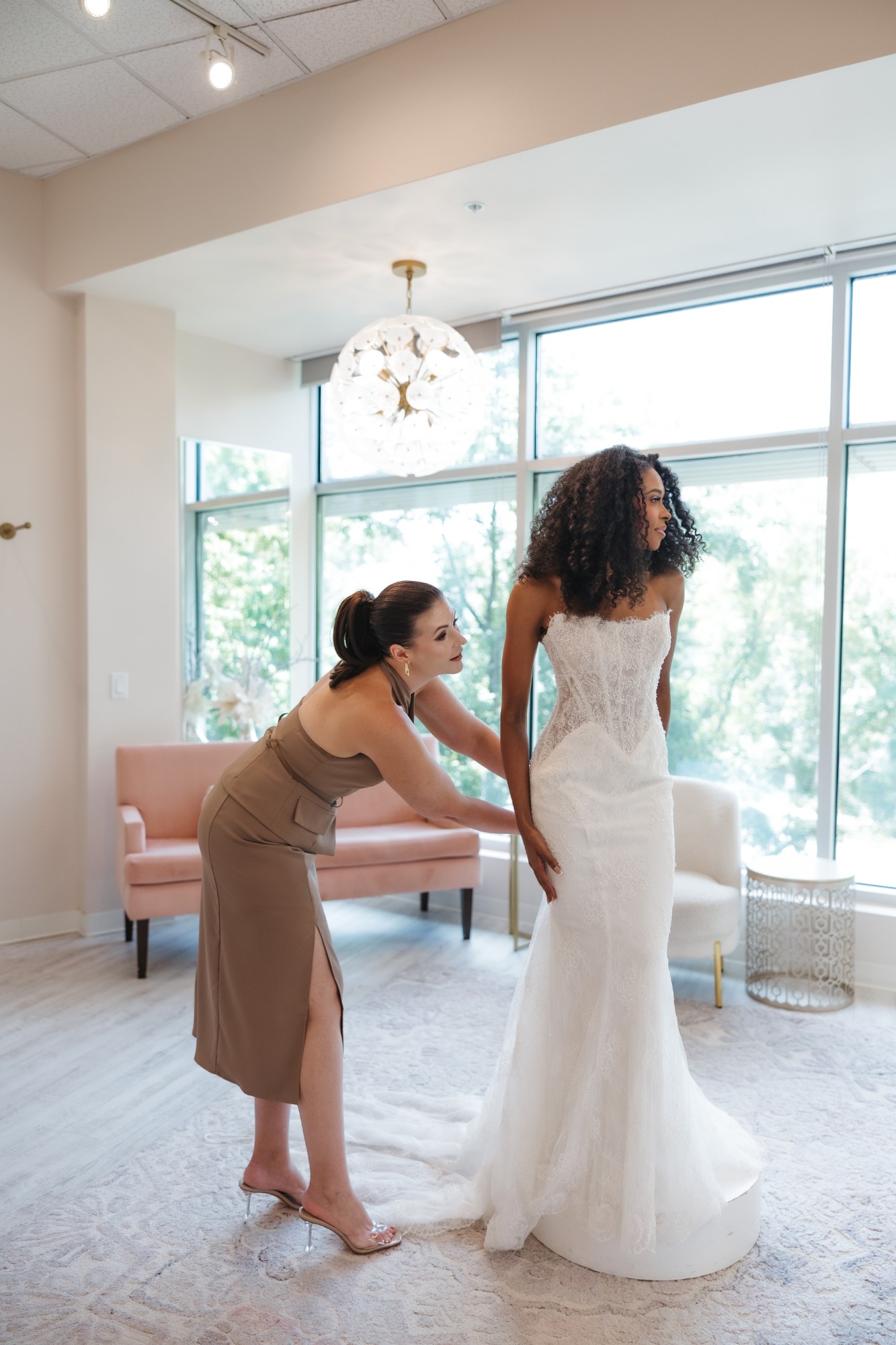 Stylist fitting the back of the Martina Liana ML2010 gown on a bride