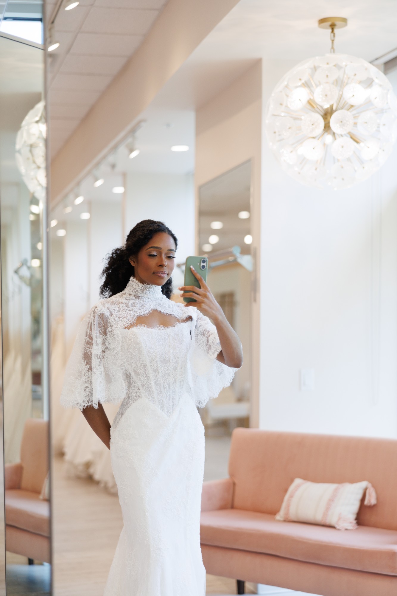 Bride admiring the Martina Liana ML2010 high-neck lace cape in the mirror