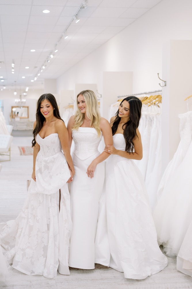 Three brides wearing different wedding gown silhouettes